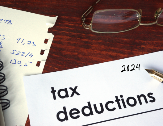 deesk with paper and words tax deductions 2024