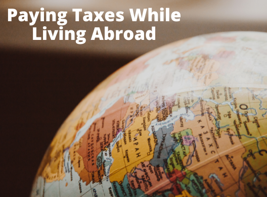 world globe and words Paying Taxes Wile Living Abroad