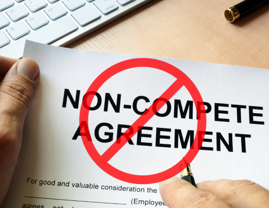 non-compete agreement papers with red line crossing it off