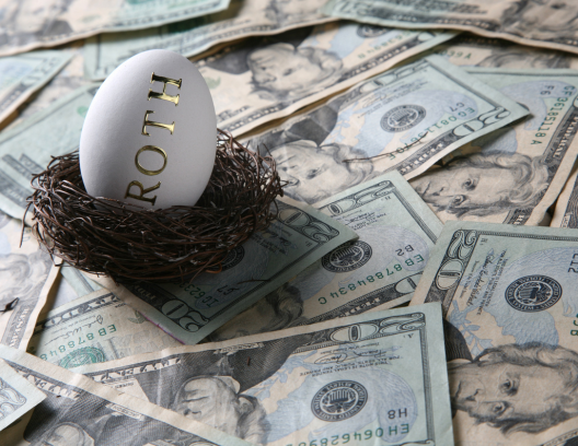 egg in nest with Roth written on it sitting on top of pile of money