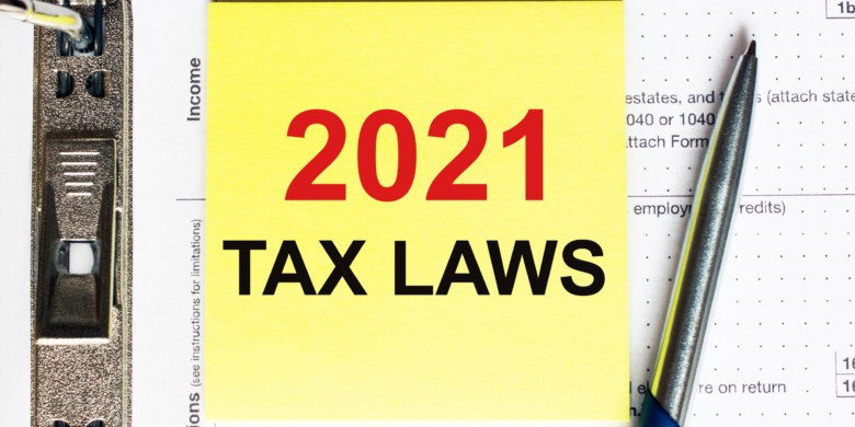 Yellow post-it note with 2021 Tax Laws written on it
