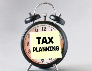 clock with tax planning sticky note